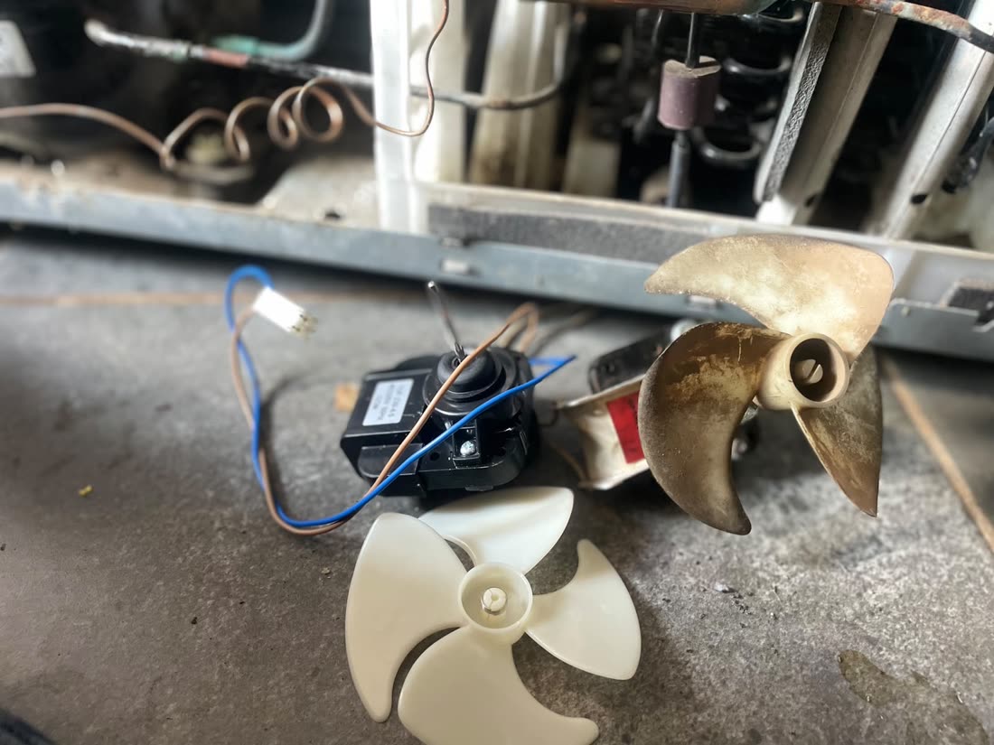 Fan blades and motor parts removed during a repair
