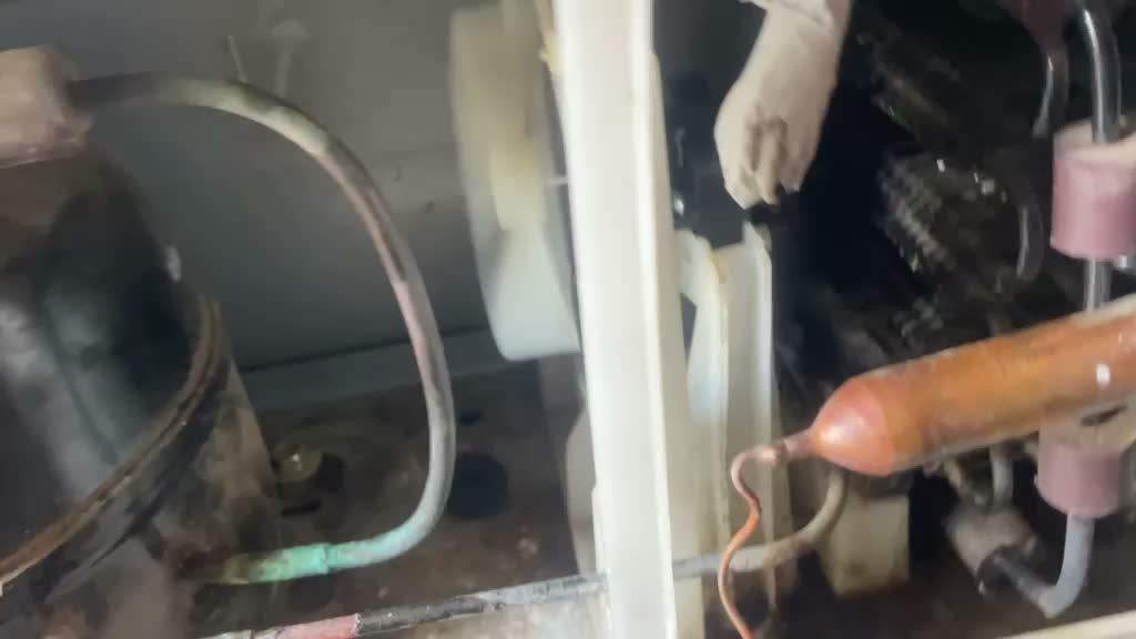 Technician brazing copper refrigeration pipework on site